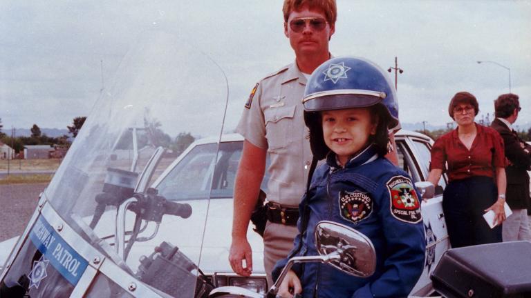 Chris with local police officer on motorcycle